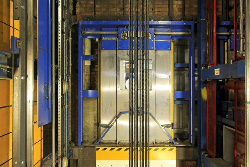 Modern elevator shaft interior with cables and tracks
